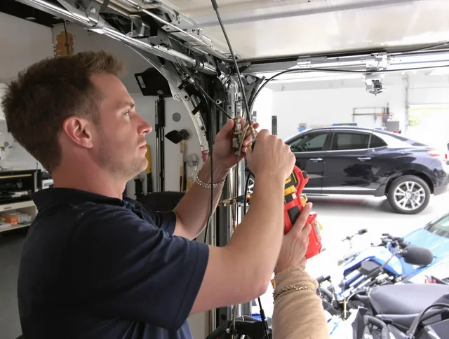 Naugatuck Garage Door Repair safety certified technician performing cable replacement in Naugatuck